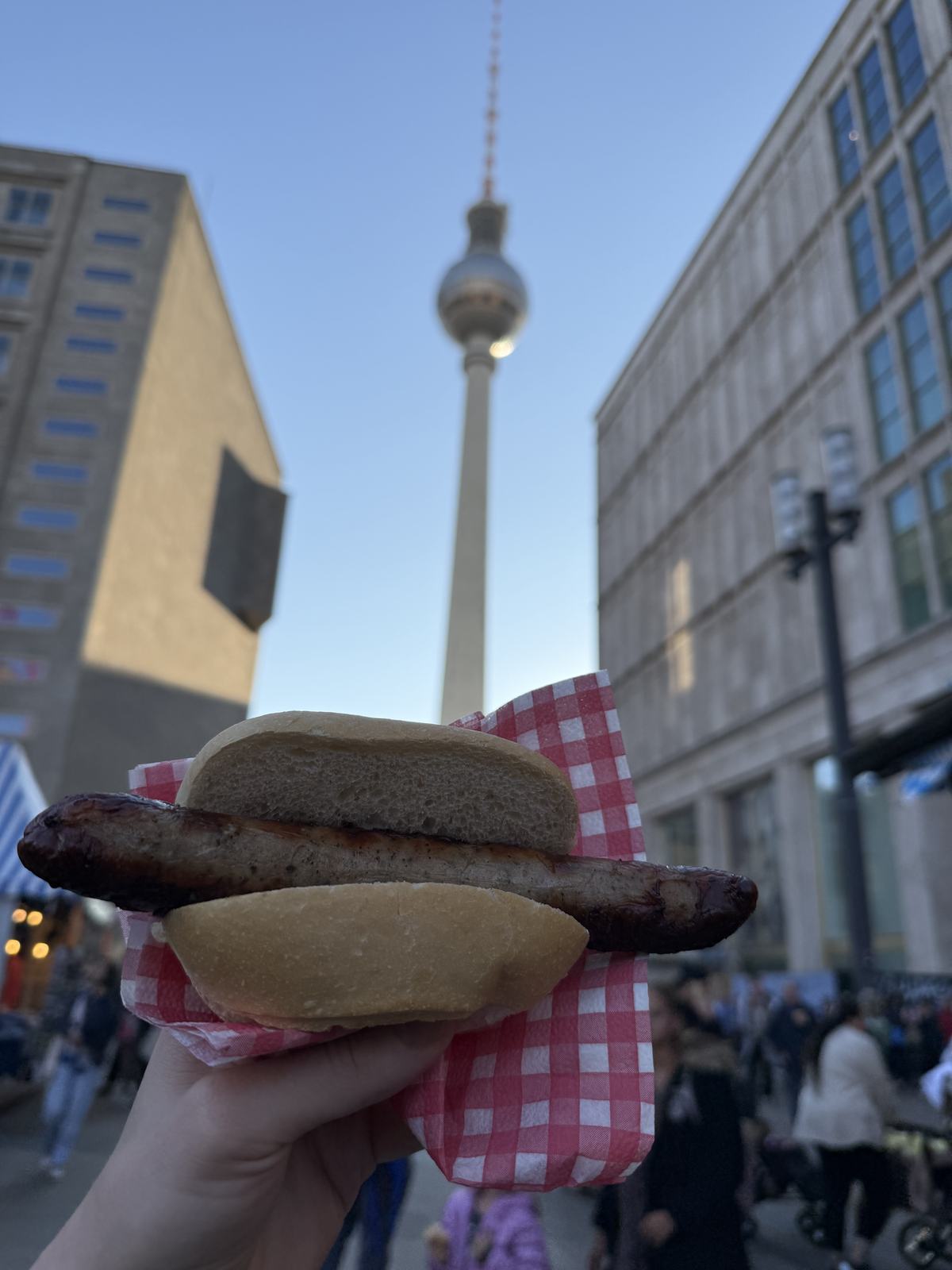 A Bratwurst held up against the TV tower