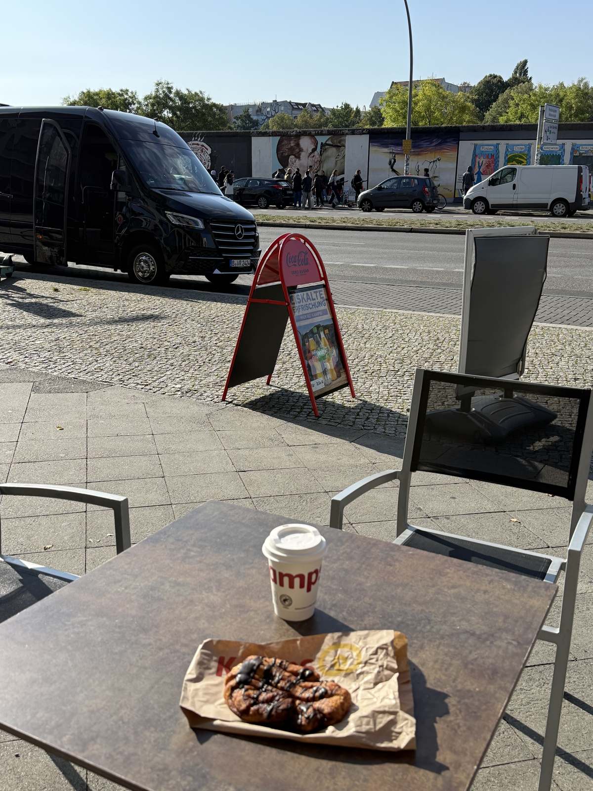 Currywurst and a coffee on a table by the wall