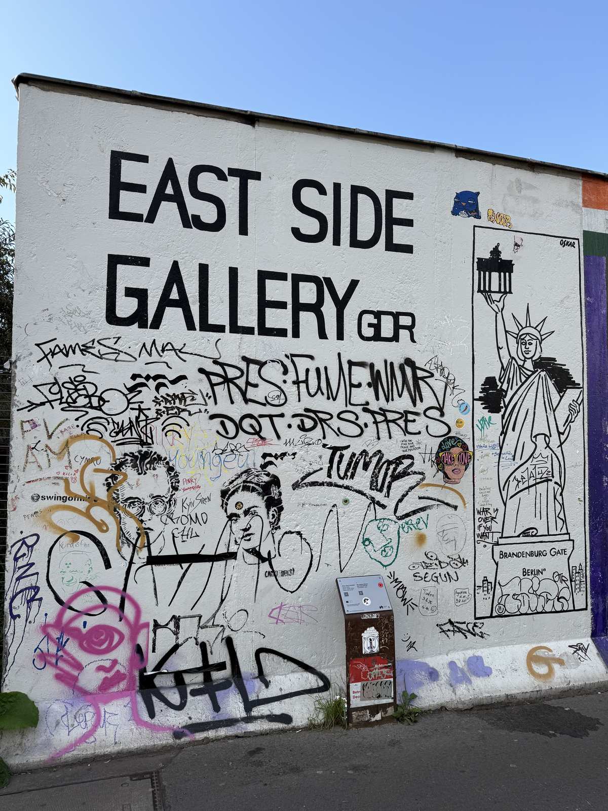 The East Side Gallery sign painted on the wall