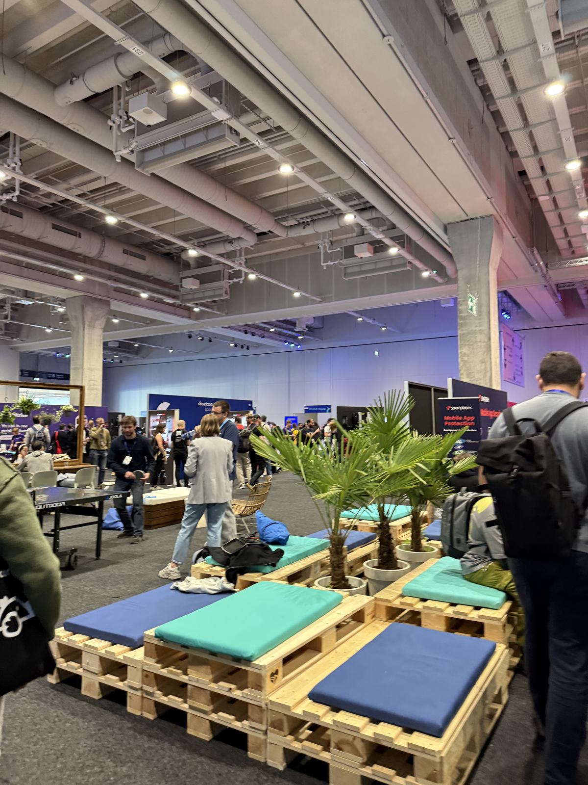 Pallet seating and palms in the middle of the expo floor