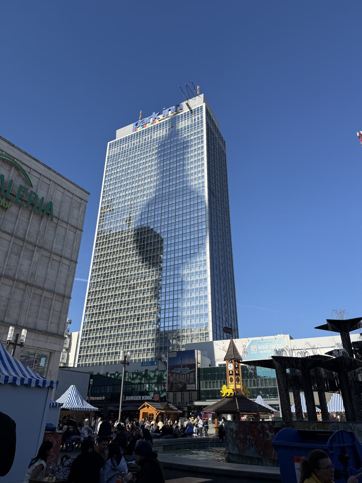The shadow of the TV tower cast on the glass facade of the Park Inn