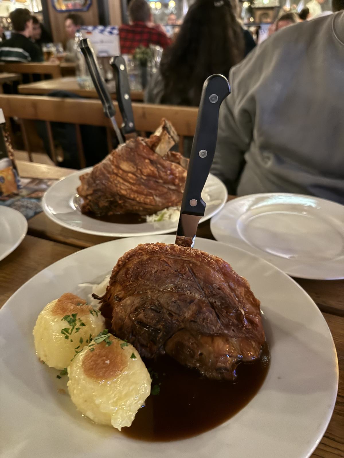 A Schweinshaxe with a knife stuck in it