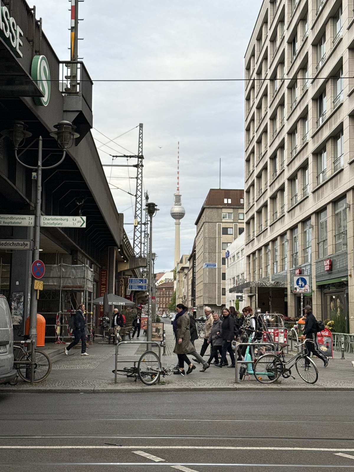 A Berlin street at dusk with the TV tower at the end of it