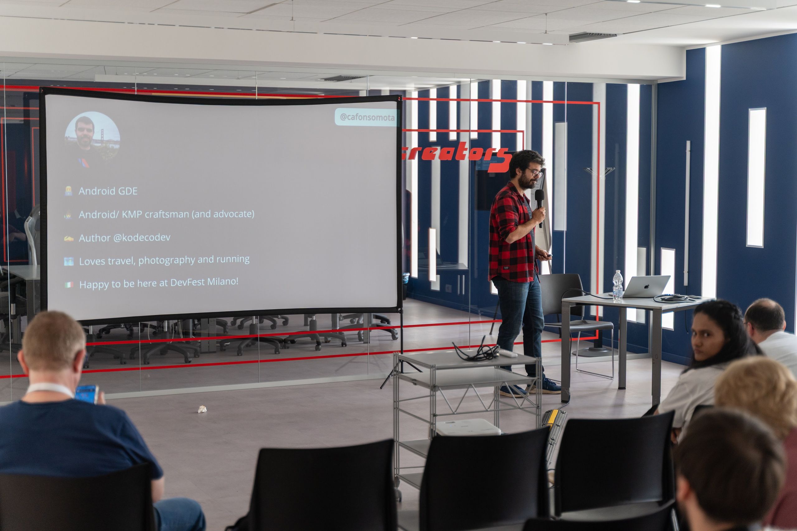 A speaker beside the projection screen in the big room