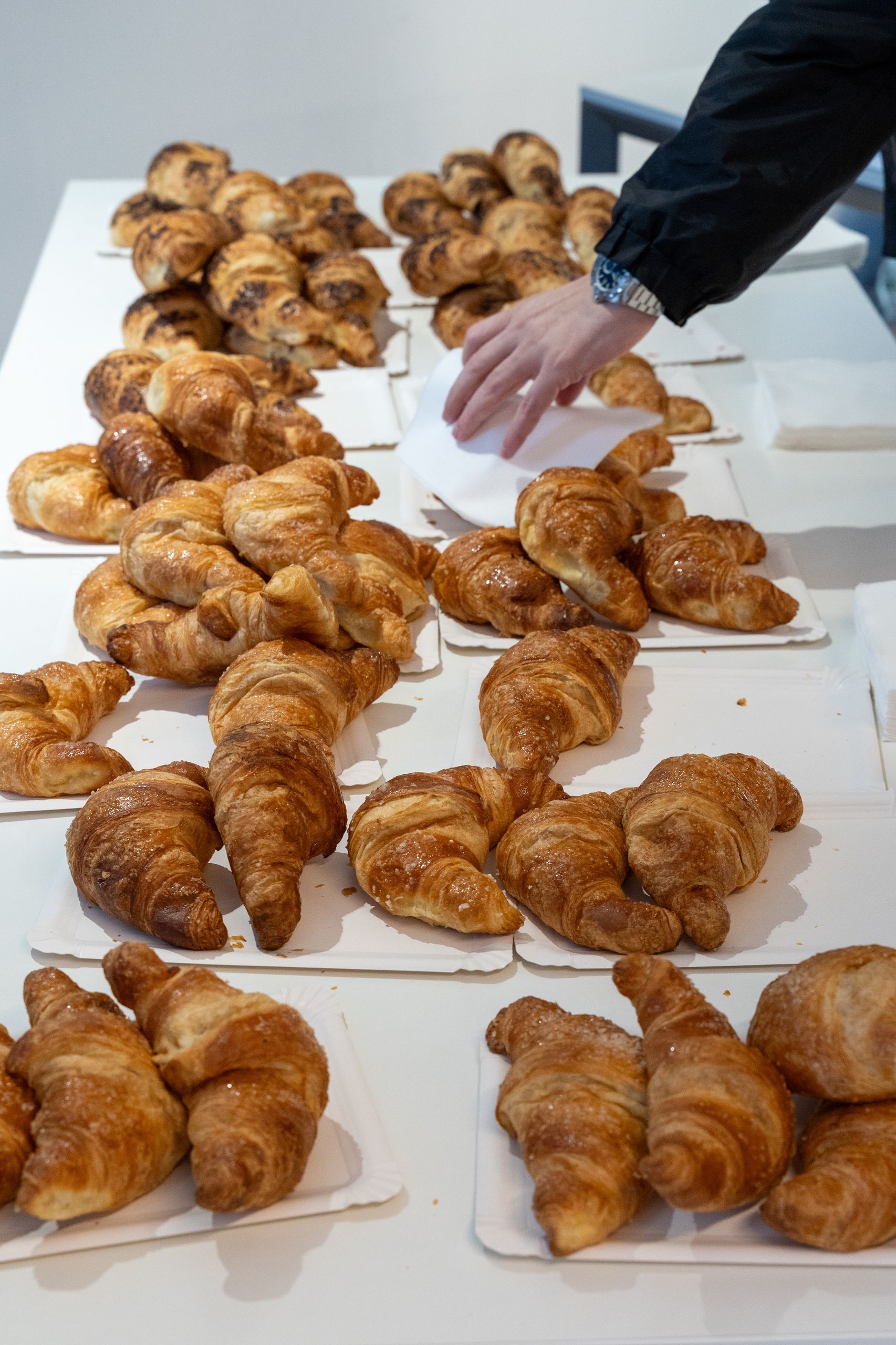 A table covered in croissants at the breakfast before the conference