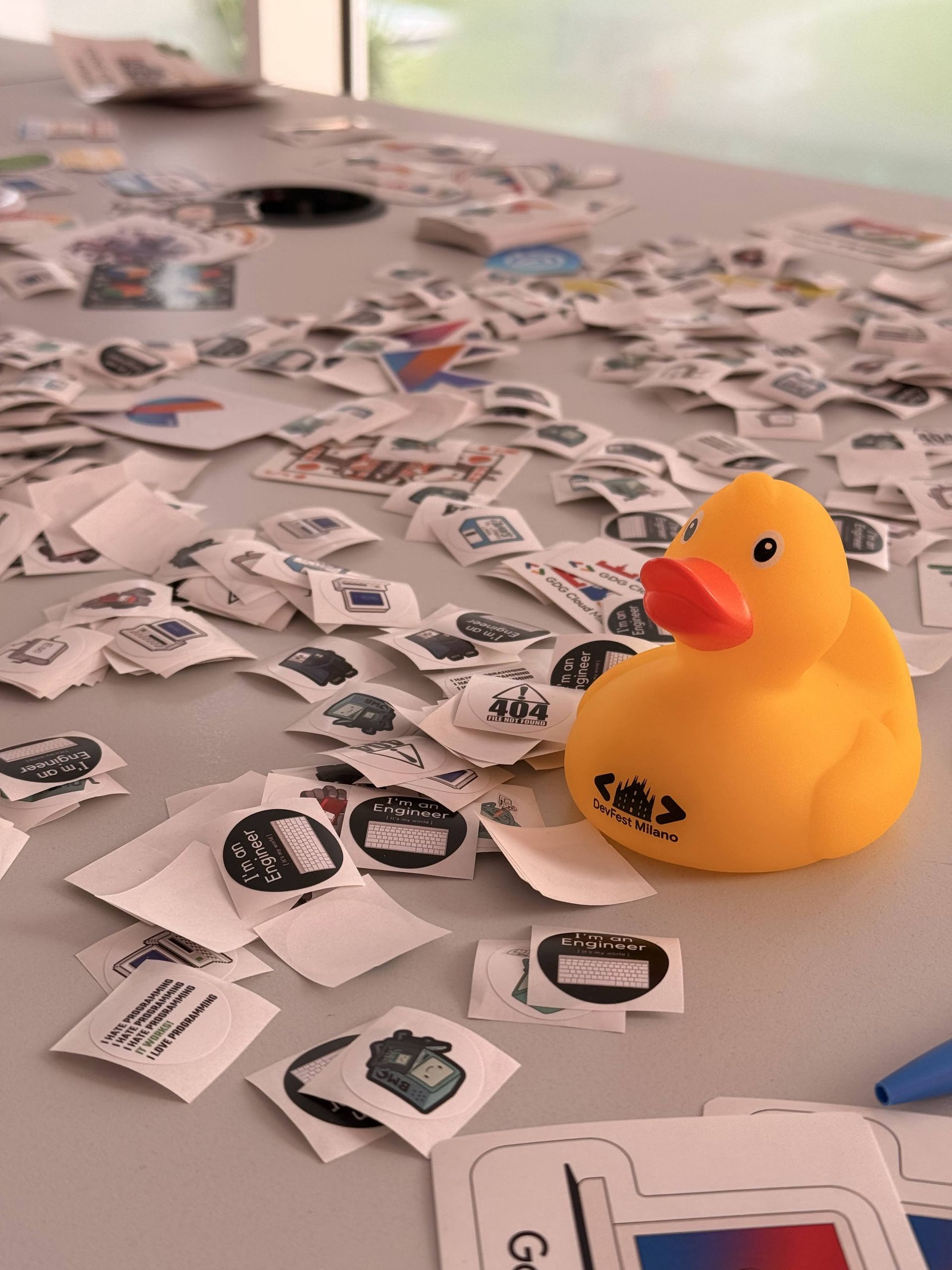A yellow rubber duck among the stickers on the swag swap table
