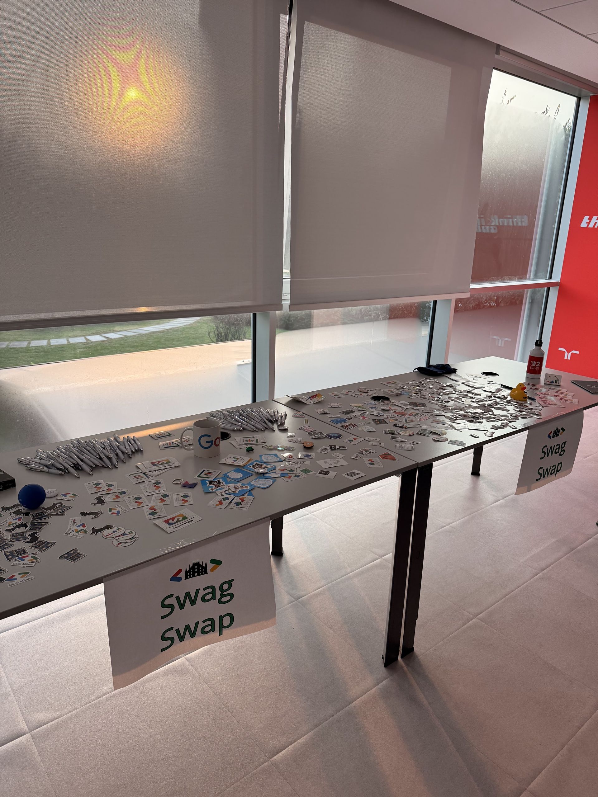 A long table with the sign swag swap covered in stickers
