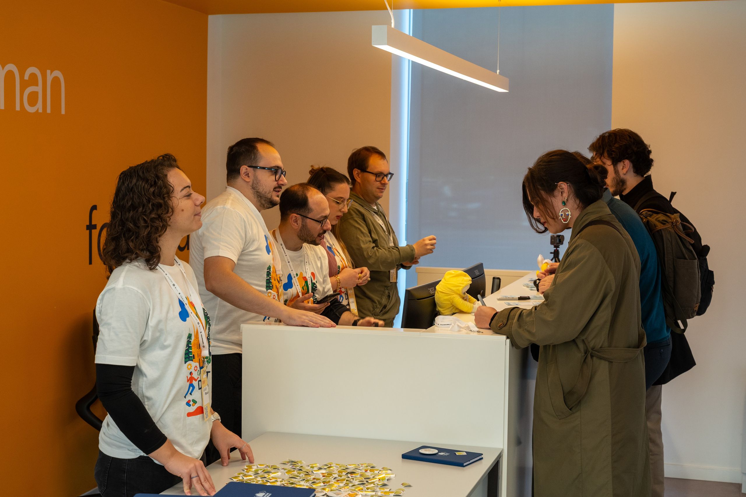 Volunteers in DevFest t-shirts behind the welcome desk