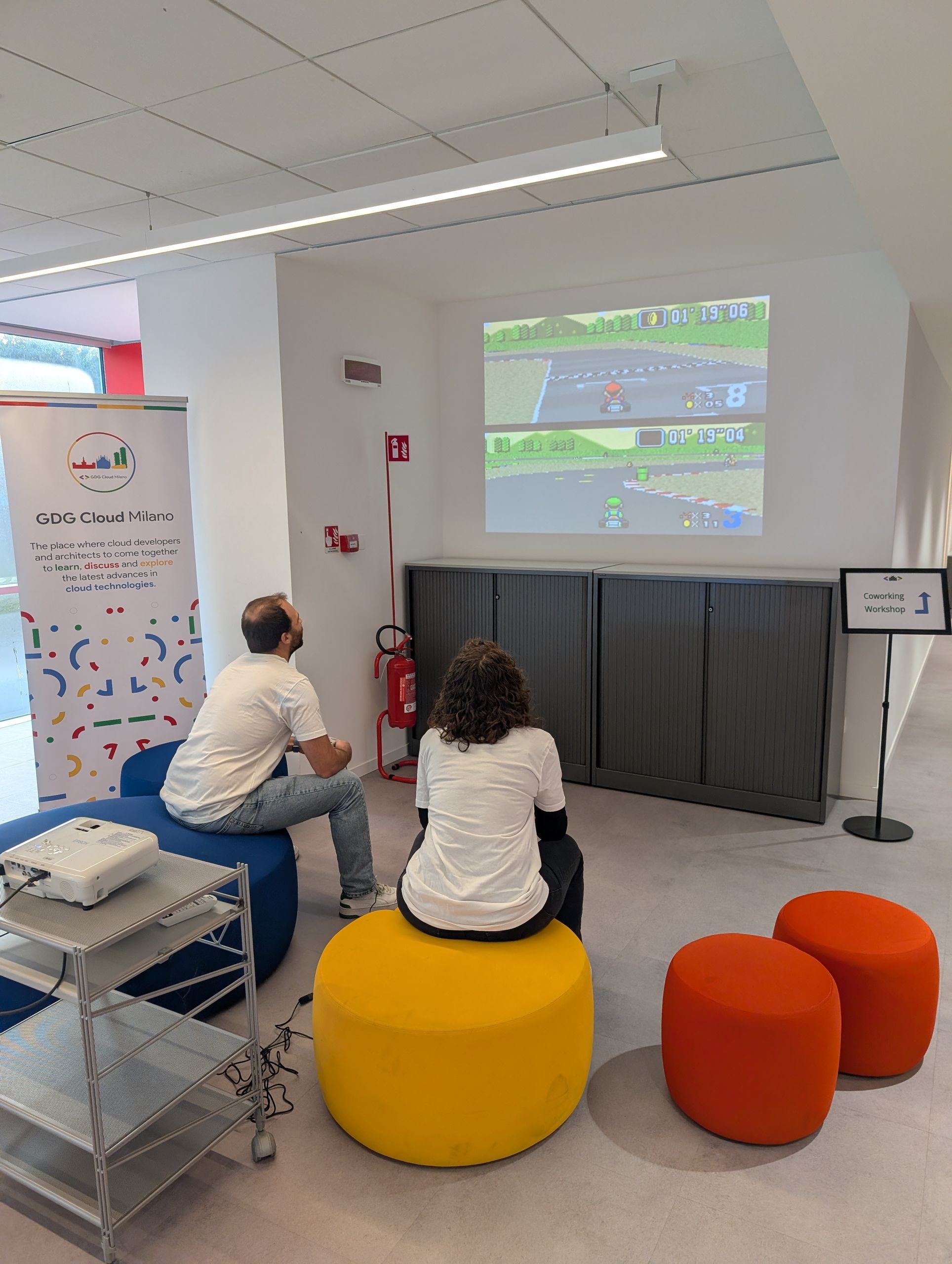 The small room with a projection and the GDG Cloud Milano banner