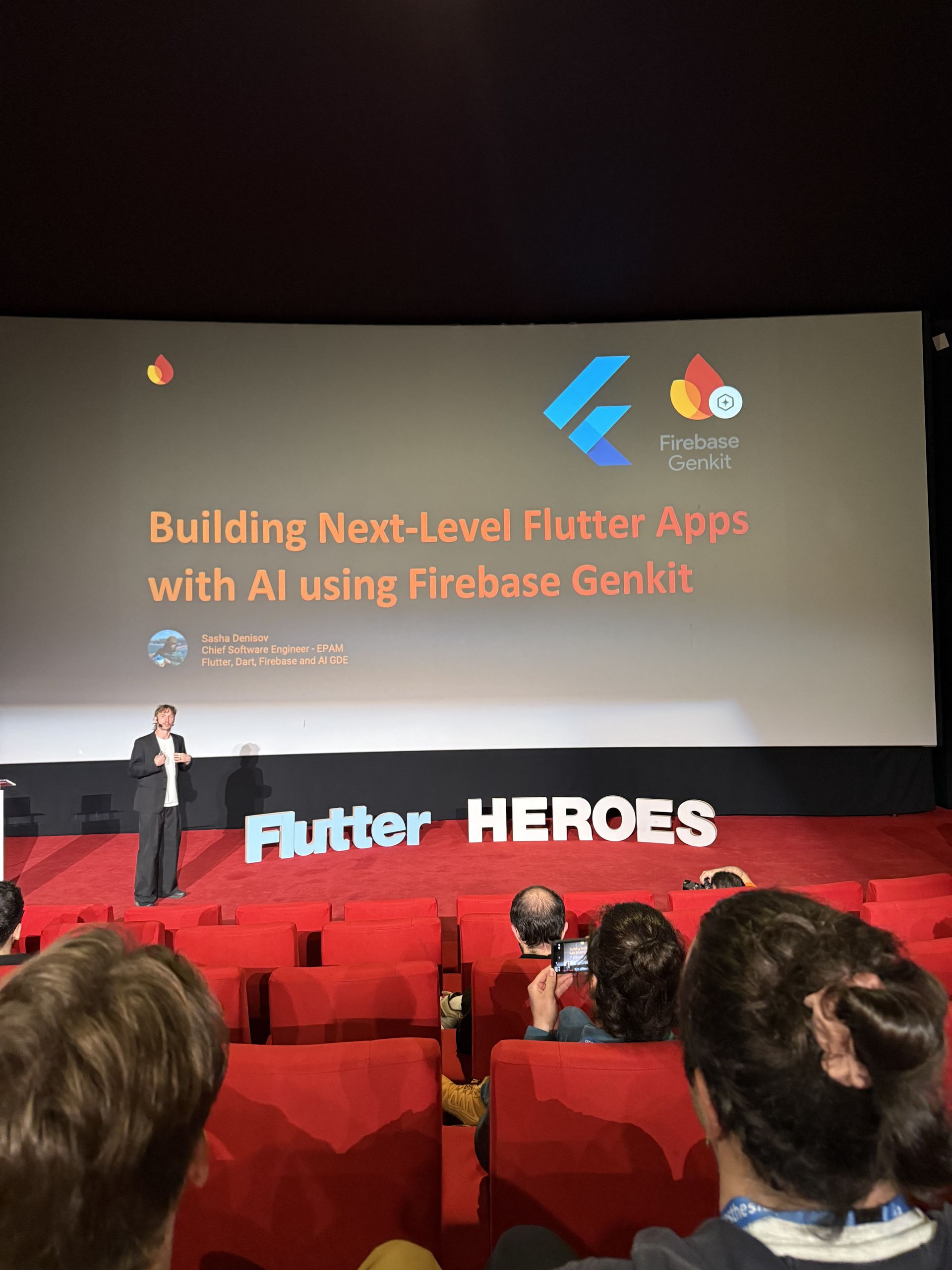 The Building Next-Level Flutter Apps with AI using Firebase Genkit talk on the cinema screen
