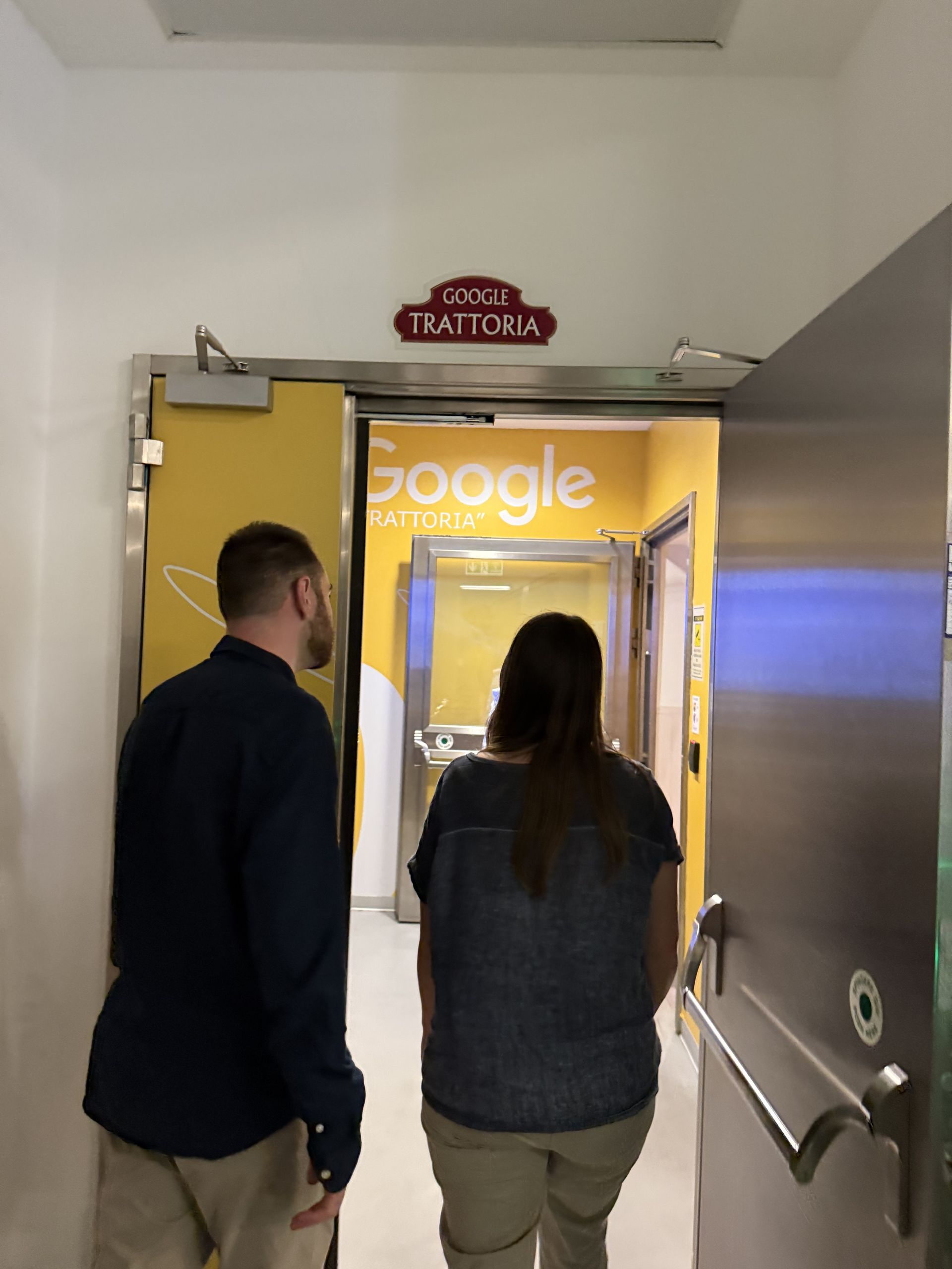 The door to the office canteen with the Google Trattoria sign above it