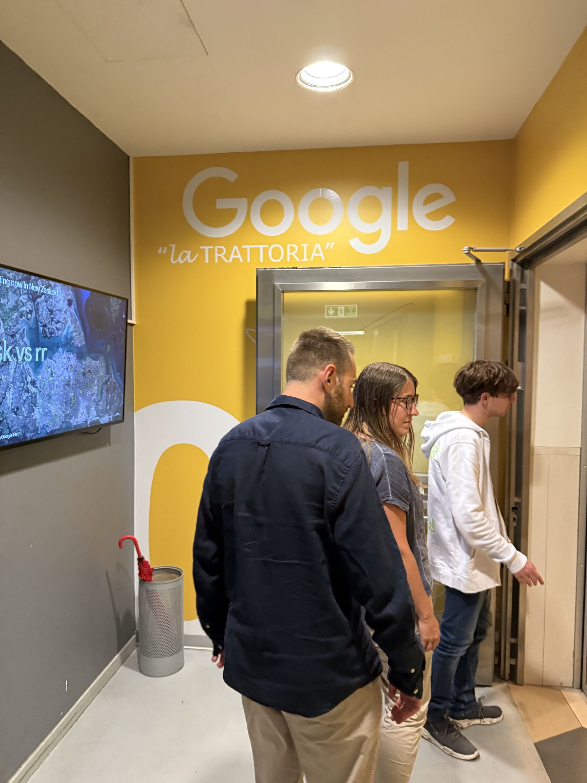 The yellow wall of the canteen with Google la Trattoria written on it