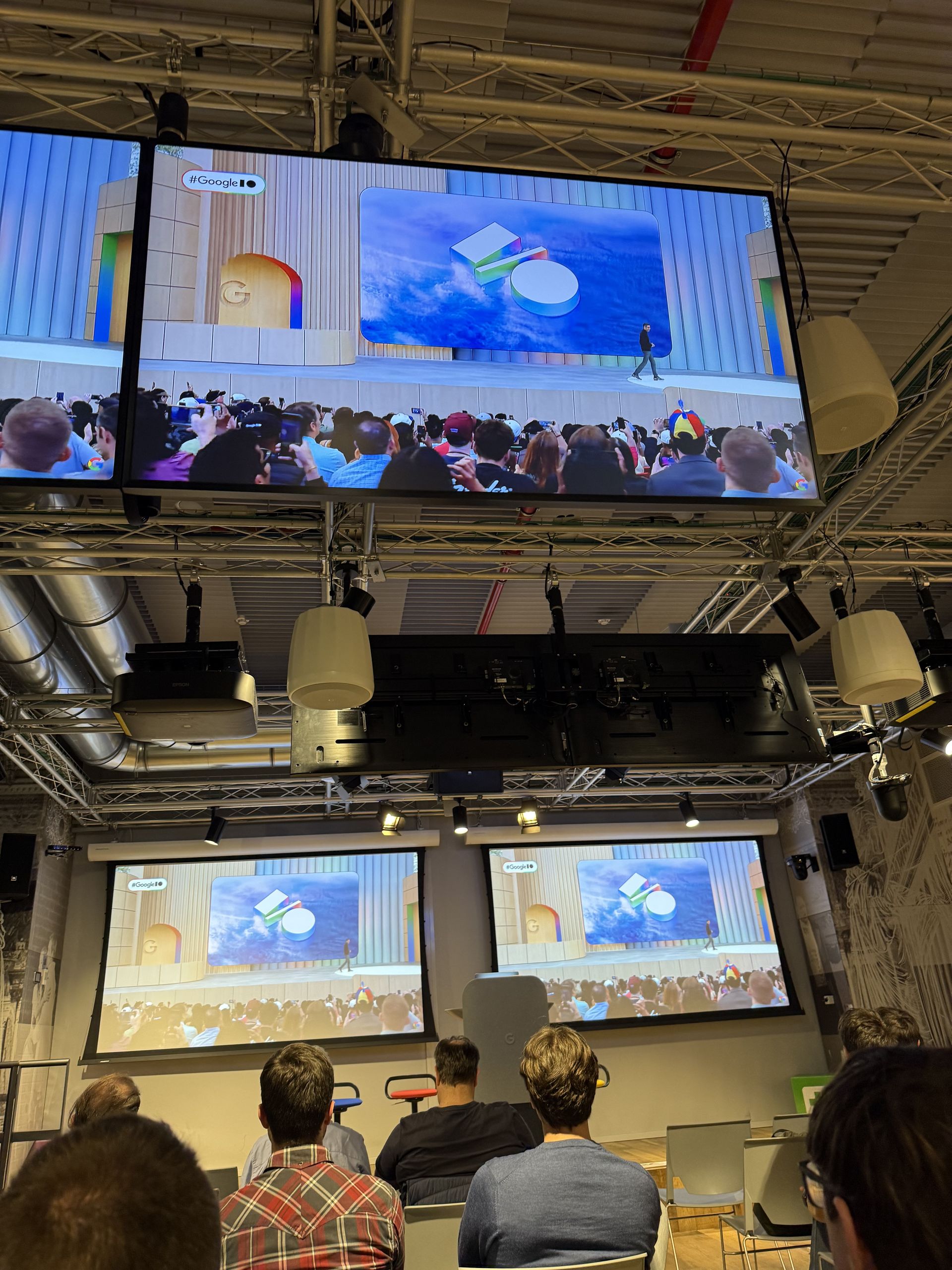 The I/O stage on screen with the hashtag Google I/O and the live crowd below