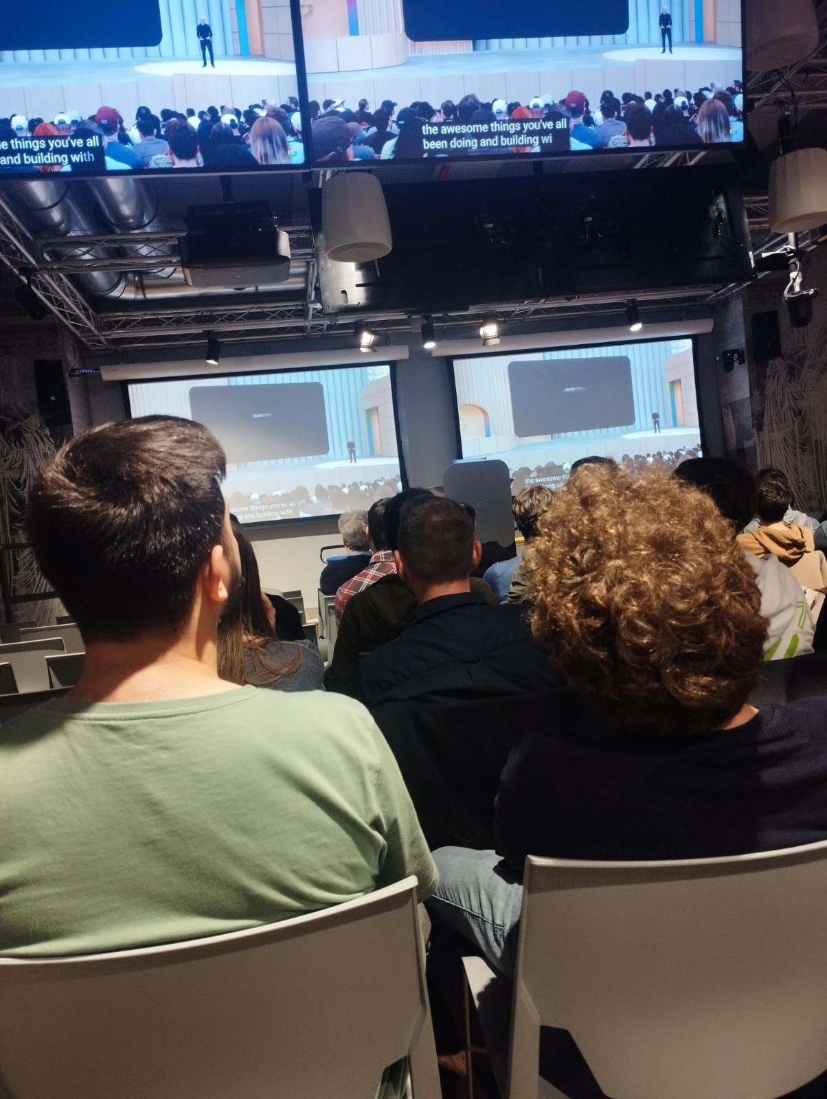 The audience watching the keynote from the back rows