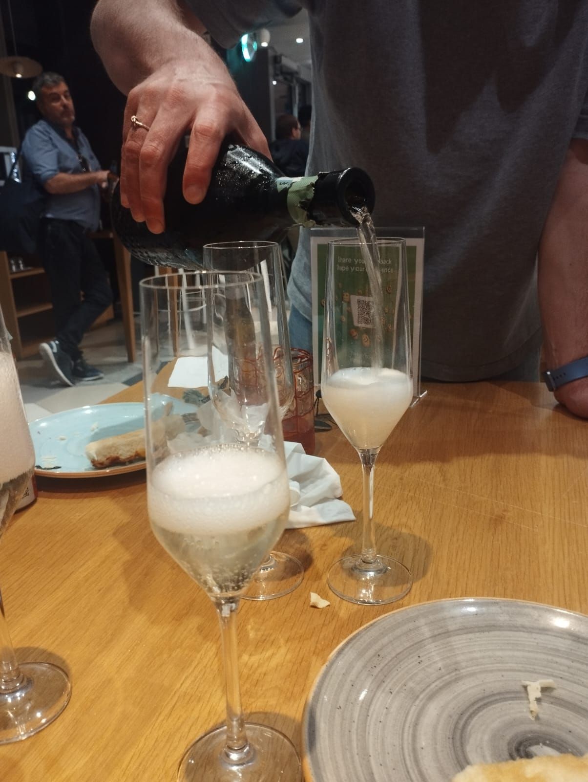 Prosecco being poured into glasses at the community dinner