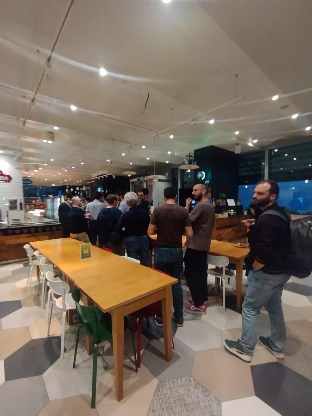 The canteen with people standing and talking after the keynote