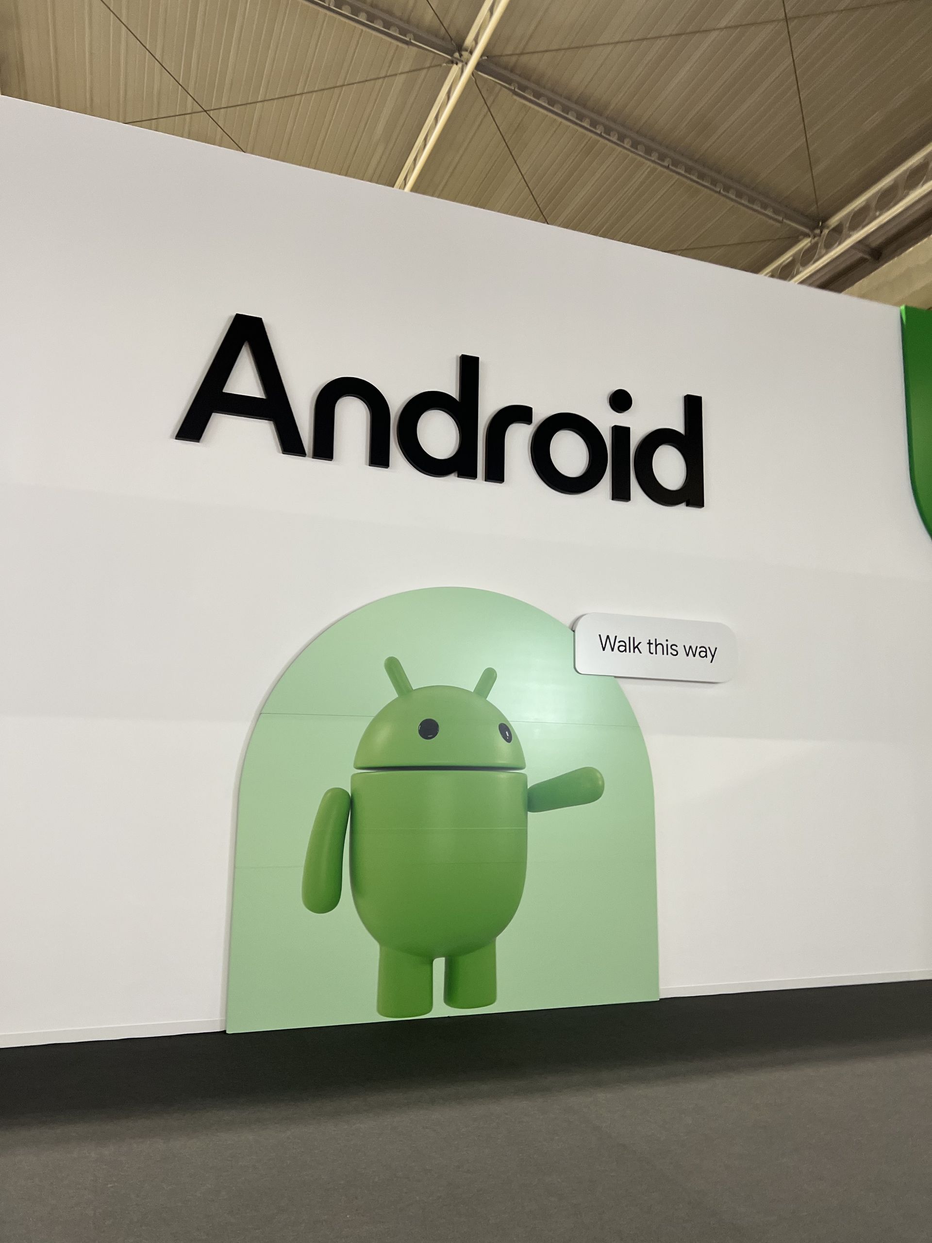 Android wall with the green robot and a Walk this way speech bubble