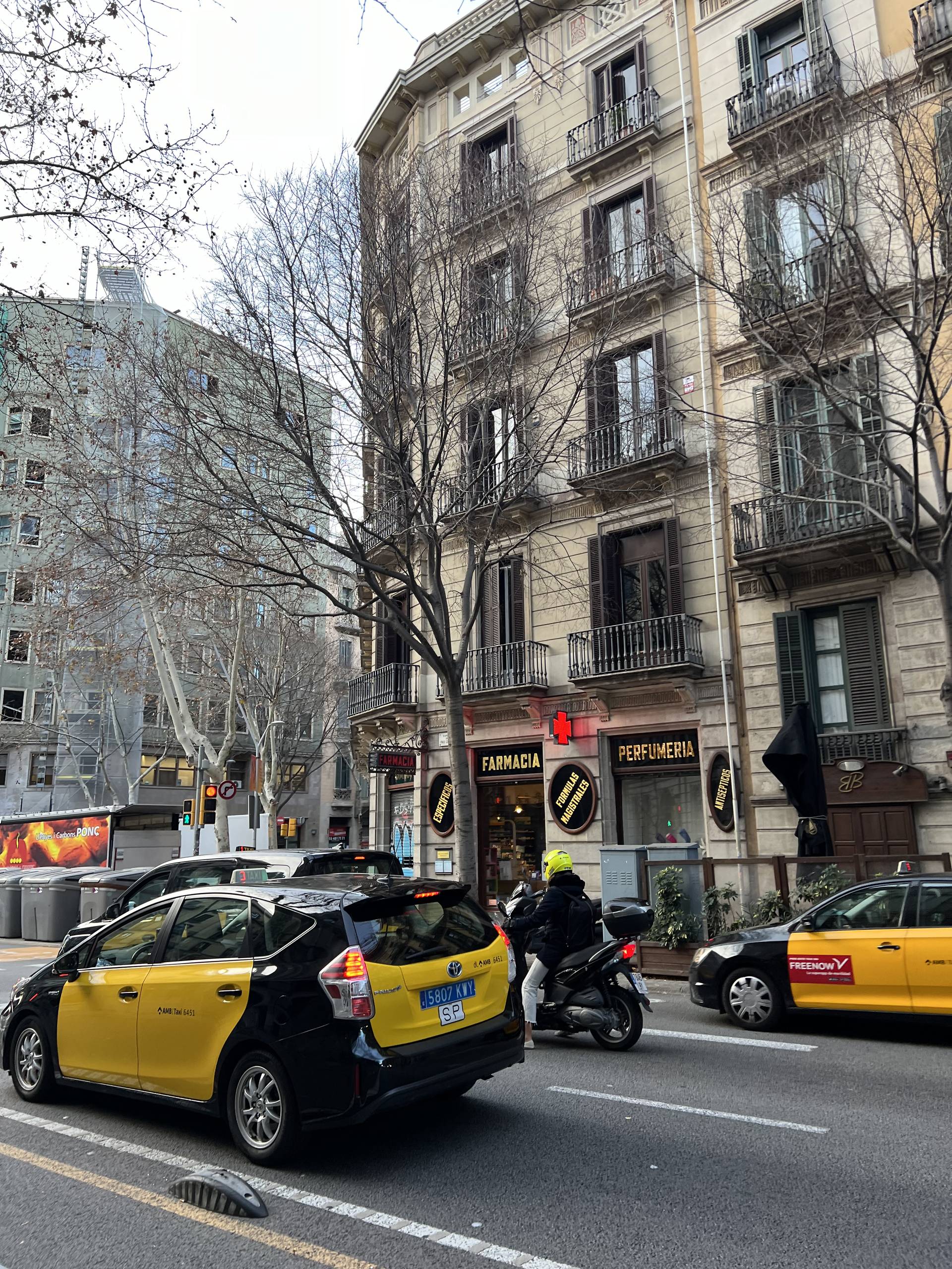 A Barcelona street in the morning with the black and yellow taxis