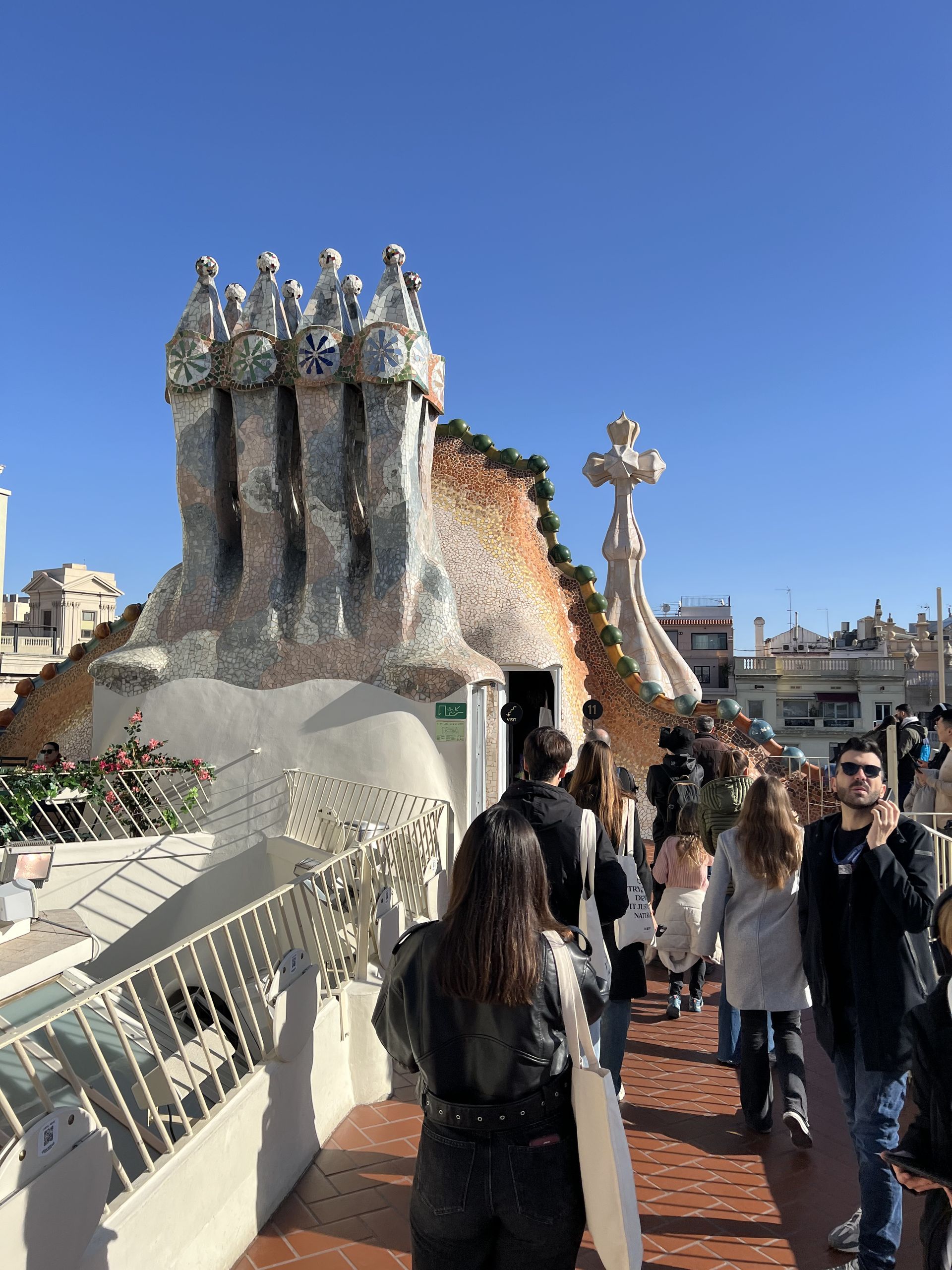 The dragon's back ridge of the Casa Batlló roof with the turret and cross