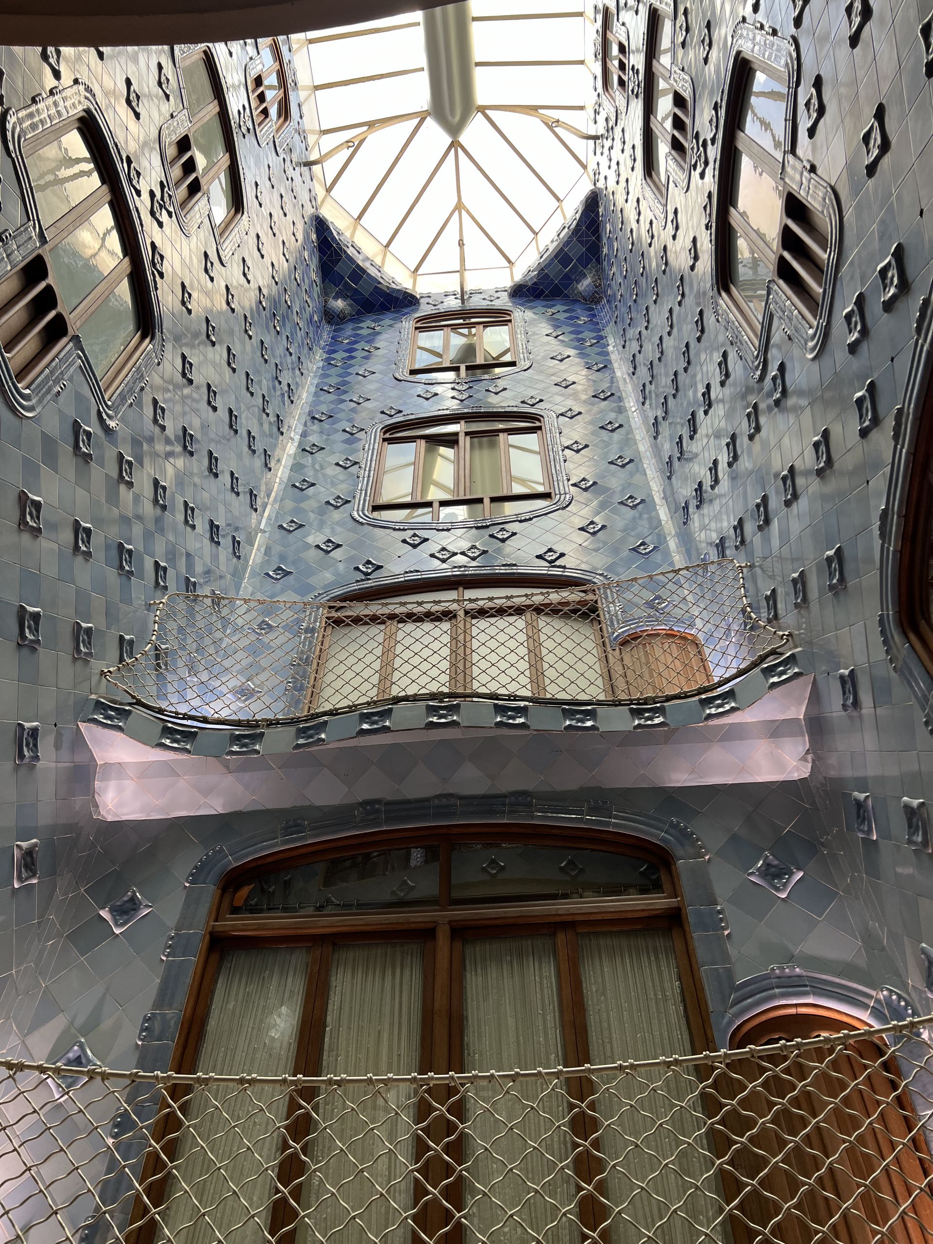 The blue-tiled light well of Casa Batlló seen from below