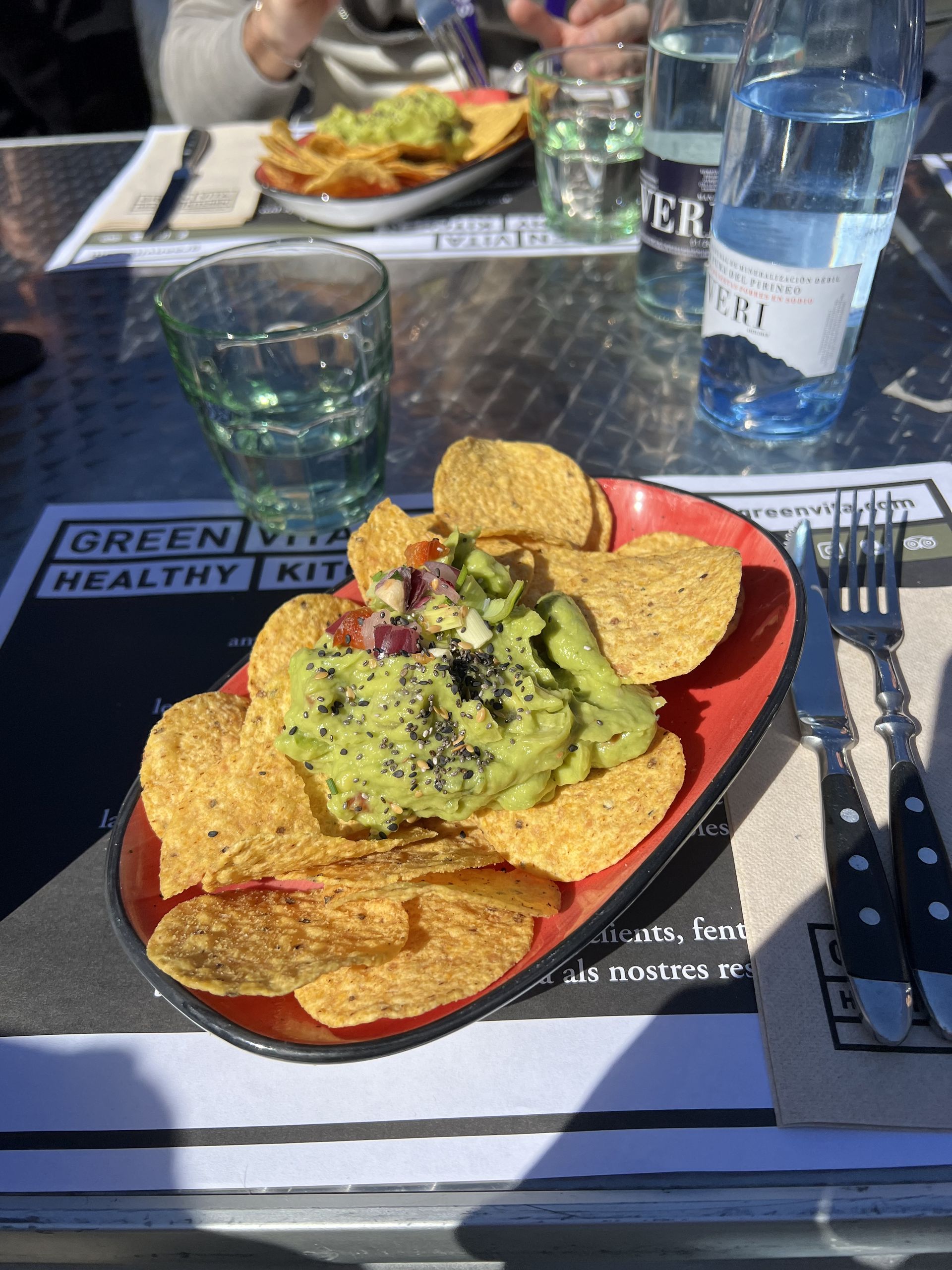 Guacamole with nachos on a table at a restaurant near the Fira