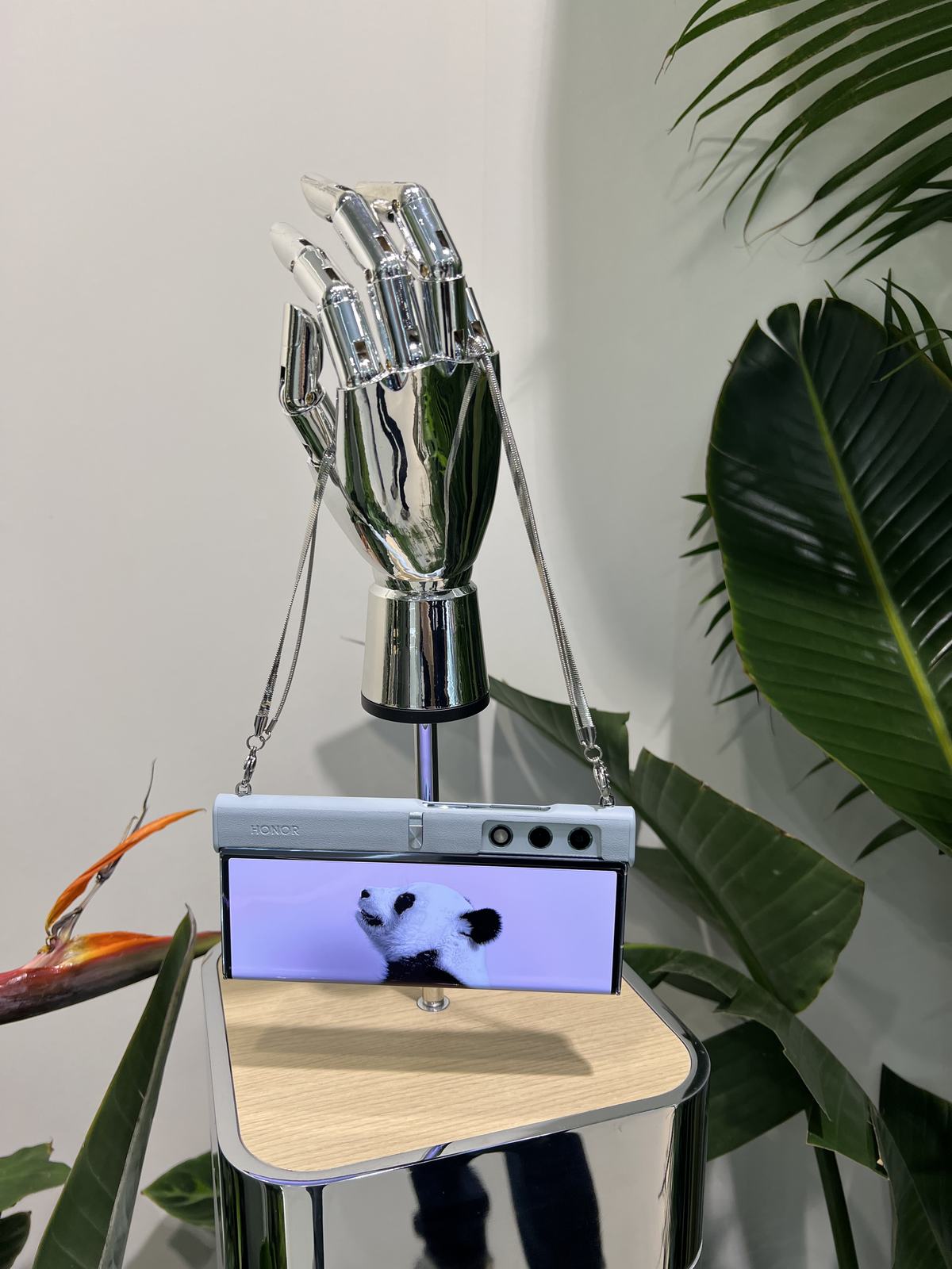 A robotic hand holding the HONOR foldable