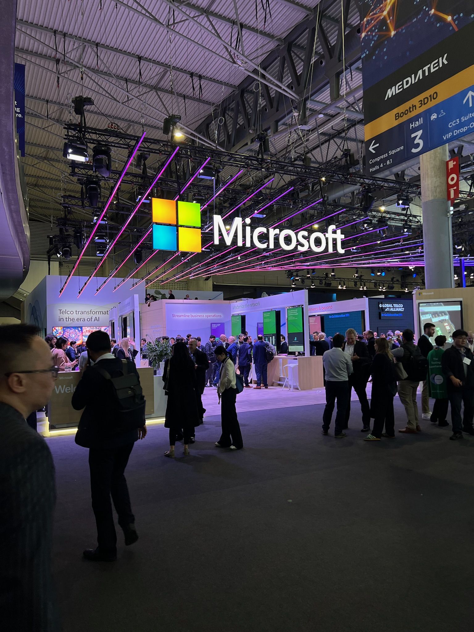 The Microsoft stand with the logo lit up over the crowd