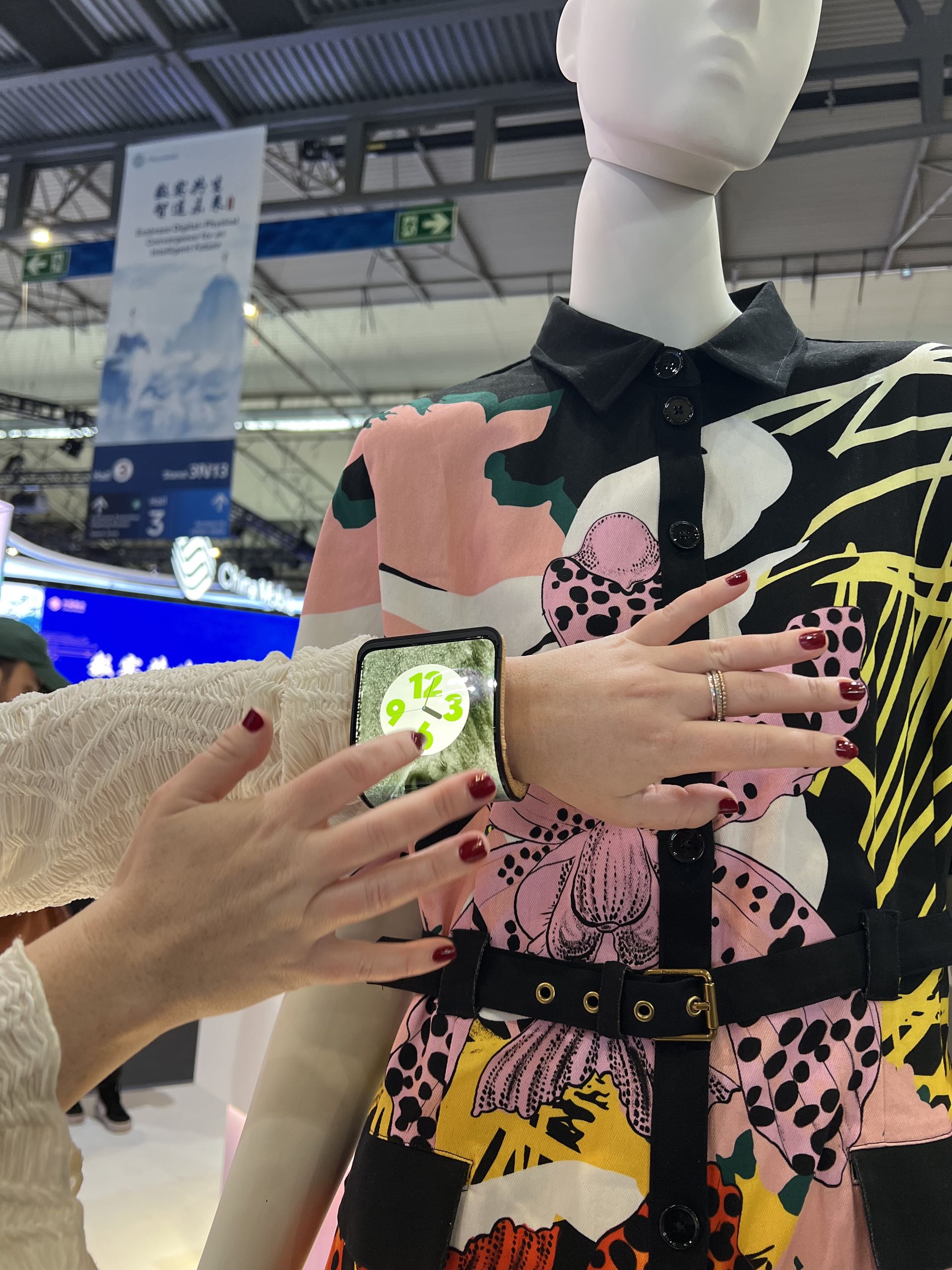 The Motorola bendable phone wrapped around a mannequin's wrist showing a watch face