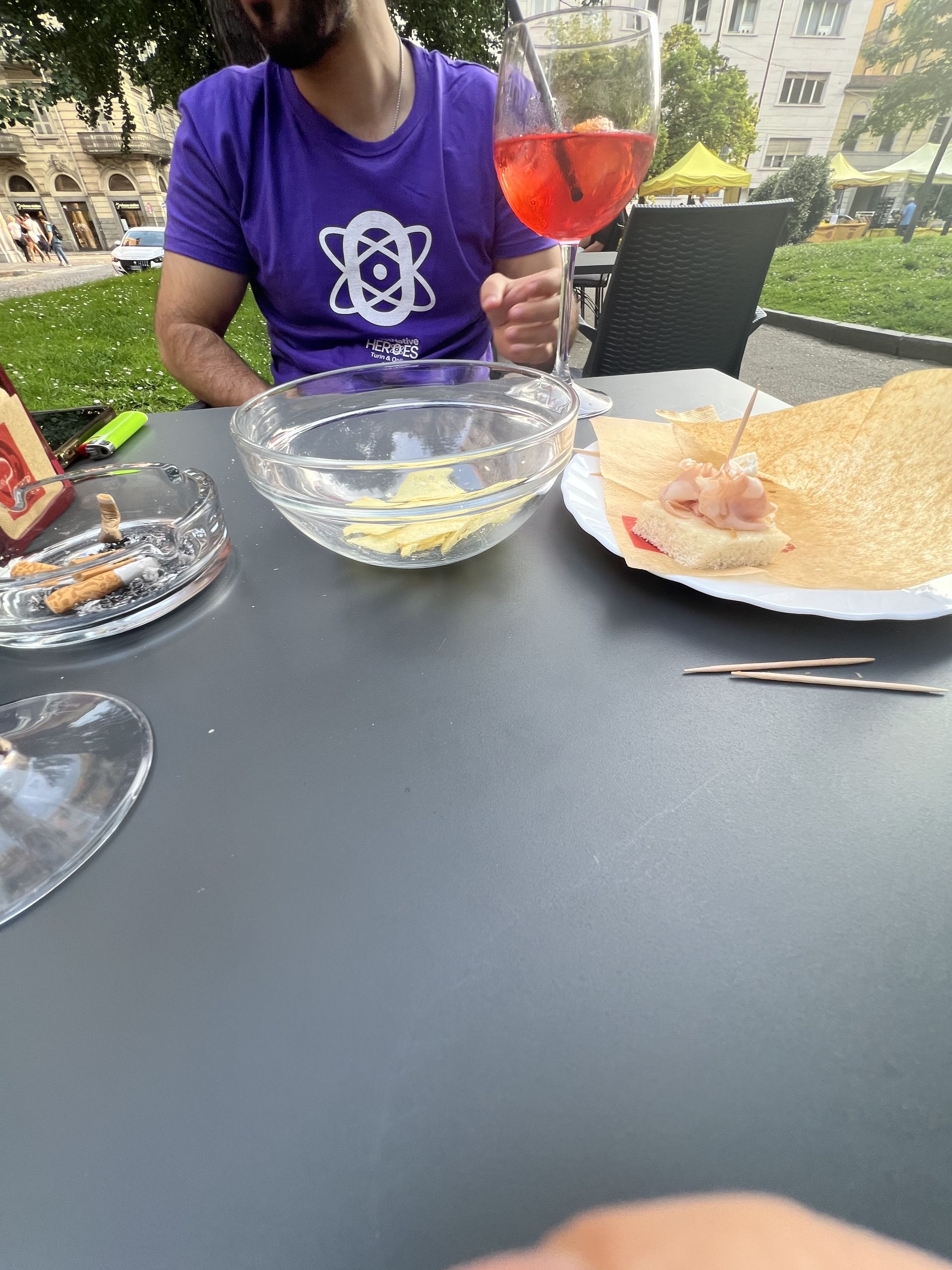 An aperitivo with a spritz and a plate of ham, with someone in the purple React Native Heroes t-shirt