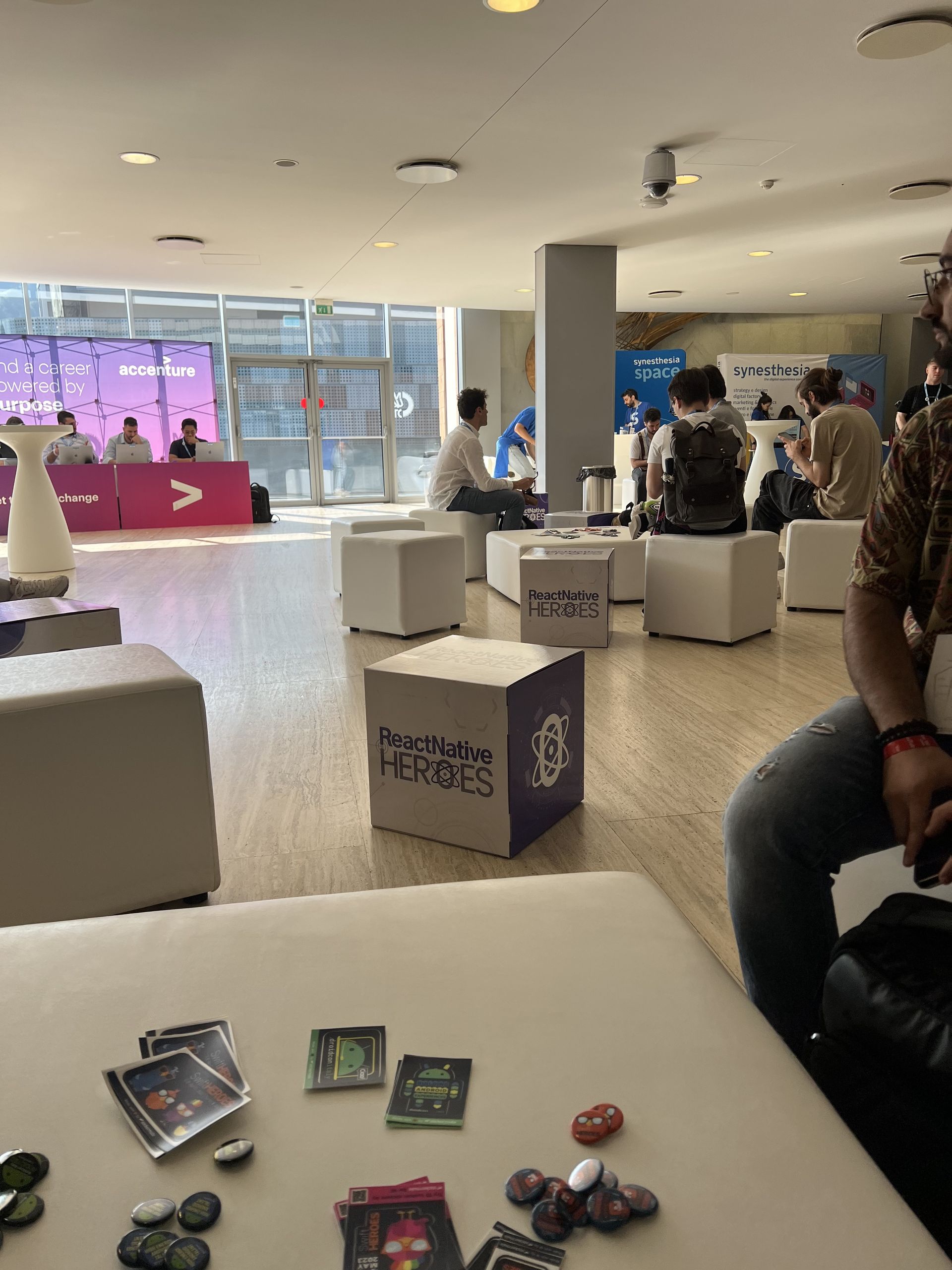 The lounge area of the conference with attendees sitting and talking